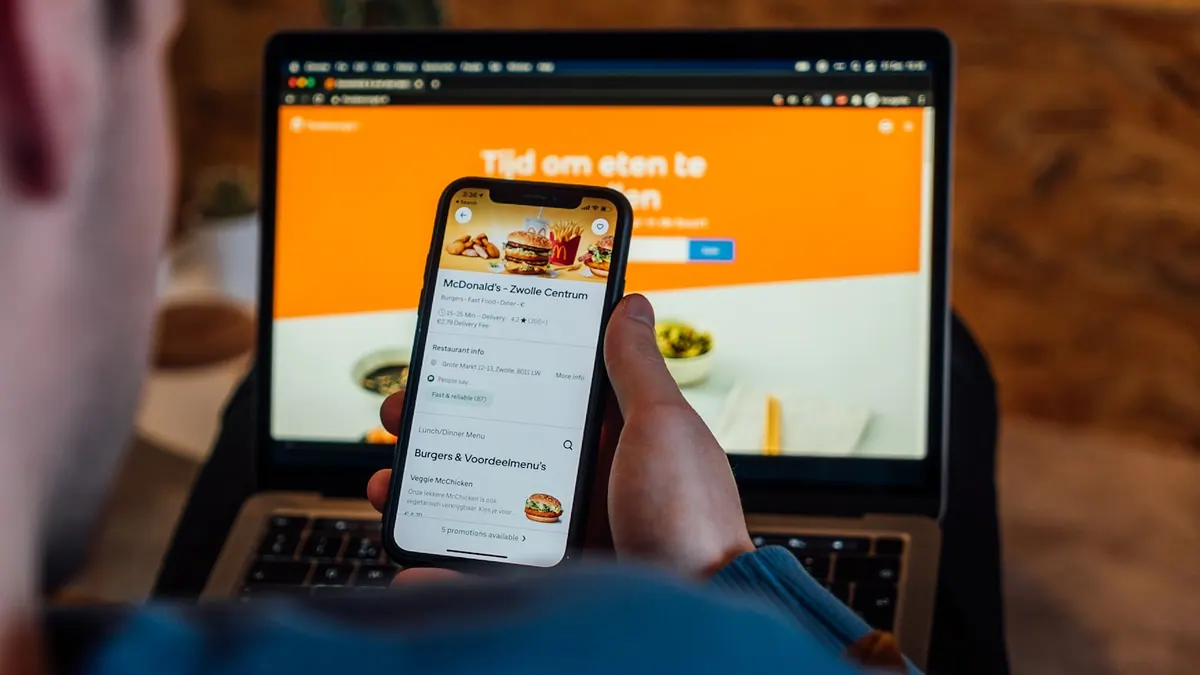 A guest browsing a restaurant menu on a phone at the table